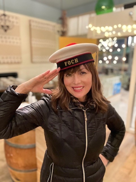Loni wearing a Foch sailor hat inside the bistro.